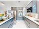Modern kitchen featuring sleek gray cabinetry, stainless steel appliances, and a bright, open design at 751 Pine Shores Cir, New Smyrna Beach, FL 32168