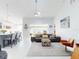 Bright living room featuring a view into the kitchen, modern ceiling fan, and comfortable seating at 751 Pine Shores Cir, New Smyrna Beach, FL 32168