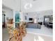 Open-concept living area with a bar, comfortable seating, and a glimpse into the modern kitchen at 751 Pine Shores Cir, New Smyrna Beach, FL 32168