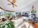 Expansive living space blending a sunroom, bar area, and living room, ideal for gatherings and relaxation at 751 Pine Shores Cir, New Smyrna Beach, FL 32168