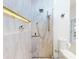 This walk-in shower features light stone tiles, rainfall shower head, and a built-in shelf at 751 Pine Shores Cir, New Smyrna Beach, FL 32168