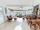 Bright sunroom with multiple seating areas, bamboo accents, and lots of natural light at 751 Pine Shores Cir, New Smyrna Beach, FL 32168