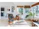 Bright sunroom with rattan furniture, woven blinds, and a view to the outside creating a tranquil space at 751 Pine Shores Cir, New Smyrna Beach, FL 32168