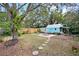 Spacious backyard with a charming shed, mature trees, and a swing for outdoor enjoyment at 817 E 20Th Ave, New Smyrna Beach, FL 32169