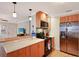 Kitchen featuring wood cabinets, stainless steel refrigerator, and modern appliances at 817 E 20Th Ave, New Smyrna Beach, FL 32169