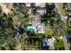 Aerial view of the property and pool highlighting the layout and surrounding landscape and wooded parcel at 820 Faulkner St, New Smyrna Beach, FL 32168