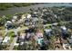 Aerial view of a neighborhood with a large in-ground pool in the backyard at 820 Faulkner St, New Smyrna Beach, FL 32168
