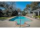 Swimming pool surrounded by lush tropical foliage in a private backyard setting, sunny day at 820 Faulkner St, New Smyrna Beach, FL 32168
