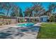 Backyard showcasing an in-ground pool and lush landscaping, fenced in for privacy and security at 820 Faulkner St, New Smyrna Beach, FL 32168