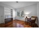Bedroom featuring light wood floors, white built-in shelves and large windows at 820 Faulkner St, New Smyrna Beach, FL 32168