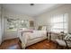 Cozy bedroom with bright windows, warm wood floors, and calming neutral tones at 820 Faulkner St, New Smyrna Beach, FL 32168