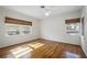 Bright bedroom featuring warm wood floors and sunny windows with natural window shades at 820 Faulkner St, New Smyrna Beach, FL 32168