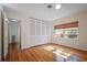Bright bedroom featuring warm wood floors, a window, and closet with bi-fold doors at 820 Faulkner St, New Smyrna Beach, FL 32168