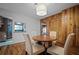 Dining room with wood flooring, wood paneling and a wooden table with seating for four at 820 Faulkner St, New Smyrna Beach, FL 32168