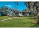 Charming single-story home with a well-manicured lawn and inviting walkway at 820 Faulkner St, New Smyrna Beach, FL 32168
