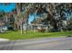 Charming single-story home with lush lawn and mature trees, as seen from the street at 820 Faulkner St, New Smyrna Beach, FL 32168