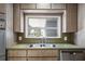 Kitchen sink beneath a window featuring a double basin, with wood cabinets above and below at 820 Faulkner St, New Smyrna Beach, FL 32168