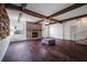 Spacious living room with beamed ceilings, brick fireplace, and hardwood floors at 820 Faulkner St, New Smyrna Beach, FL 32168