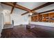 Spacious living room featuring wood beams, hardwood floors, and a charming built-in bookcase at 820 Faulkner St, New Smyrna Beach, FL 32168