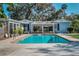 Refreshing pool with brick trim offers an inviting backyard oasis for relaxation and entertainment at 820 Faulkner St, New Smyrna Beach, FL 32168