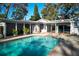 Inviting pool surrounded by a brick patio, perfect for outdoor entertaining and relaxation at 820 Faulkner St, New Smyrna Beach, FL 32168