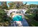 Backyard featuring a sparkling pool and well-maintained landscaping at 820 Faulkner St, New Smyrna Beach, FL 32168
