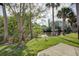 Backyard view featuring mature trees and picturesque view of a serene body of water at 848 Pine Shores Cir, New Smyrna Beach, FL 32168