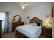 Bedroom with ceiling fan, wood floors, and a decorative dresser at 848 Pine Shores Cir, New Smyrna Beach, FL 32168