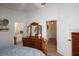 Comfortable bedroom features a dresser and a doorway leading to a bathroom at 848 Pine Shores Cir, New Smyrna Beach, FL 32168