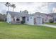 Charming single-story home featuring a well-maintained lawn, brick accents, and an attached two-car garage at 848 Pine Shores Cir, New Smyrna Beach, FL 32168
