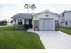 Lovely single-story home showcasing a well-manicured lawn, charming flower boxes, and an attached garage at 848 Pine Shores Cir, New Smyrna Beach, FL 32168