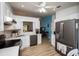 Bright kitchen featuring white cabinets, stainless steel appliances, and light wood flooring at 848 Pine Shores Cir, New Smyrna Beach, FL 32168