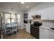 Eat-in kitchen showcasing white cabinets, modern appliances, and a cozy breakfast nook at 848 Pine Shores Cir, New Smyrna Beach, FL 32168