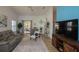 Bright living room featuring a comfortable leather sofa and a ceiling fan at 848 Pine Shores Cir, New Smyrna Beach, FL 32168