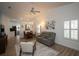 Bright living room with vaulted ceilings, neutral decor, and a connected kitchen and dining area at 848 Pine Shores Cir, New Smyrna Beach, FL 32168