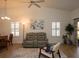 Bright living room with vaulted ceilings, neutral colors, and comfortable seating at 848 Pine Shores Cir, New Smyrna Beach, FL 32168