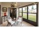 Cozy sunroom featuring wicker chairs, tile flooring, and large windows at 848 Pine Shores Cir, New Smyrna Beach, FL 32168