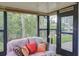 Relaxing sunroom with comfortable seating and a view of the green backyard and pond at 848 Pine Shores Cir, New Smyrna Beach, FL 32168