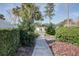 Landscaped walkway leads to neighborhood homes and community amenities at 848 Pine Shores Cir, New Smyrna Beach, FL 32168