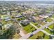 Aerial view of neighborhood, a lake and a green house with swimming pool at 921 Duncan Rd, South Daytona, FL 32119