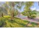 Beautiful backyard with a pool surrounded by lush tropical landscaping and a paved walkway at 921 Duncan Rd, South Daytona, FL 32119