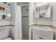 Bright bathroom with a shower, vanity, shelving and decorative mirror at 921 Duncan Rd, South Daytona, FL 32119