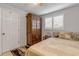 Bedroom with a wooden wardrobe, a window with white shutters, and cozy pillows at 921 Duncan Rd, South Daytona, FL 32119