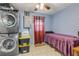 Multi-purpose room featuring a bedroom area, stackable washer and dryer, and added storage at 921 Duncan Rd, South Daytona, FL 32119