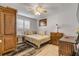 Bedroom featuring neutral tones, window shutters, and decorative artwork at 921 Duncan Rd, South Daytona, FL 32119