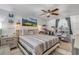 Bright bedroom with a ceiling fan, landscape art, and a unique cat climbing structure at 921 Duncan Rd, South Daytona, FL 32119