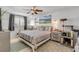Cozy bedroom with a ceiling fan, a large window, and a scenic landscape artwork at 921 Duncan Rd, South Daytona, FL 32119