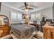 Well-lit bedroom with a ceiling fan, multiple windows, and an adjacent workspace at 921 Duncan Rd, South Daytona, FL 32119