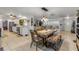 Open-concept living featuring a dining area with a wooden table, seating, and easy access to the kitchen at 921 Duncan Rd, South Daytona, FL 32119