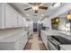 Galley kitchen with stone countertops, stainless steel appliances, tile backsplash, and bright lighting at 921 Duncan Rd, South Daytona, FL 32119